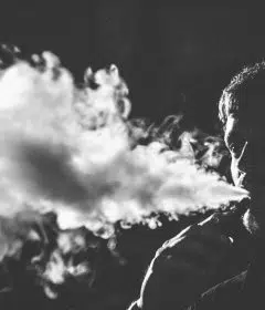 grayscale photography of smoking man