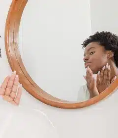 man wearing white shirt facing on wall mirror